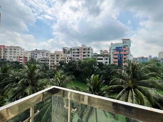 City View from Balcony with Palm Trees and Lake