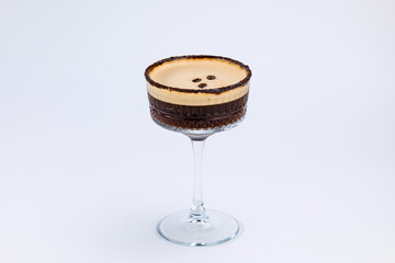 A close-up of a gourmet espresso martini garnished with coffee beans