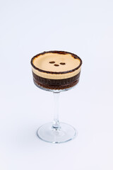 A close-up of a gourmet espresso martini garnished with coffee beans