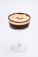A close-up of a gourmet espresso martini garnished with coffee beans