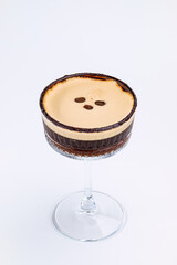 A close-up of a gourmet espresso martini garnished with coffee beans
