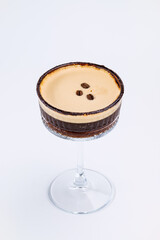 A close-up of a gourmet espresso martini garnished with coffee beans