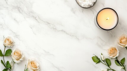 Beige roses candle and bath salts on white marble table