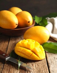 Fresh golden mangoes on a rustic wooden table