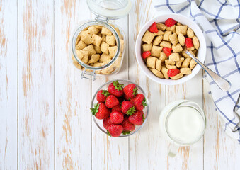 Healthy corn pillows with milk for breakfast with fruits, top view.