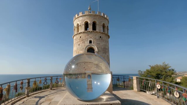 The Historic Tower of Love Constructed as Symbol of Devotion Reflected Within Crystal Sphere on Picturesque Island