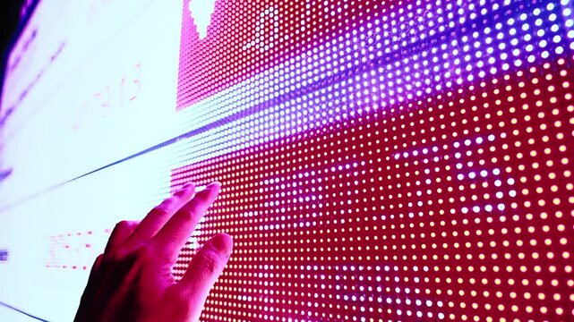 Man finger showing digital screen with graphs and charts stock market. Concept of investing money on shares, analyzing stock market and financial, slow motion