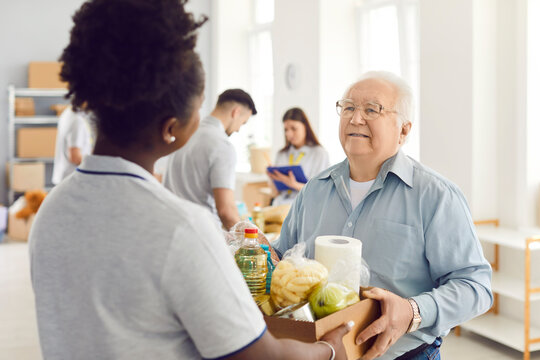 Giving help, young volunteer group working in charitable food foundation, make donation to old needy, Charity food bank, separating donations stuff, basic need provisions, free meal for elder in need