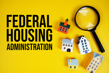 FHA Federal Housing Administration text with house models and magnifying glass on yellow background