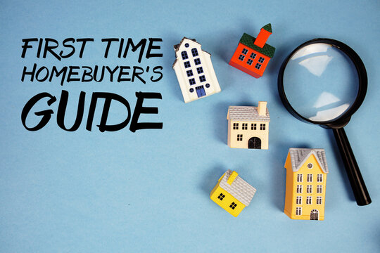 First-time Homebuyer's Guide text with house models and magnifying glass on blue background