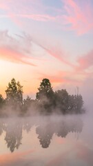 Misty sunrise over a calm lake