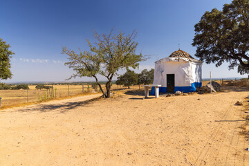 Small rural chapel standing on a dry field in Alentejo, Portugal