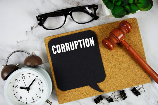 Corruption text on speech bubble with alarm clock and wooden gavel on marble background - Powered by Adobe