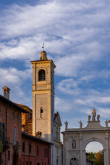 Church Tower and Arch of Cherasco in Piedmont, Italy, during Sunset