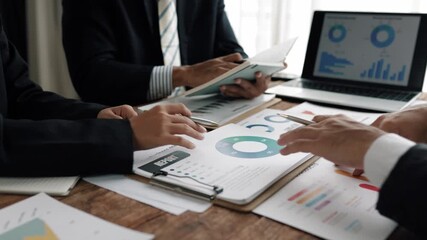 Corporate team reviewing financial charts, analyzing market trends, strategizing investment approaches in modern conference room setting - Powered by Adobe