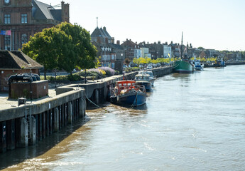 Obraz premium A view down the River Yare in Great Yarmouth in the harsh morning sun
