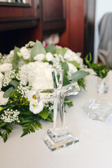 Religious wedding blessing cross with candle and holy water brush on white cloth traditional catholic christian symbol of faith and family ritual before marriage