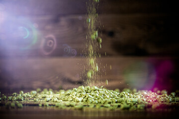 Natural green herbs falling onto a wooden surface creating a beautiful texture in a rustic kitchen setting