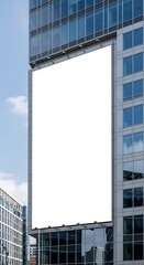 Blank billboard on the side of a modern building against a blue sky