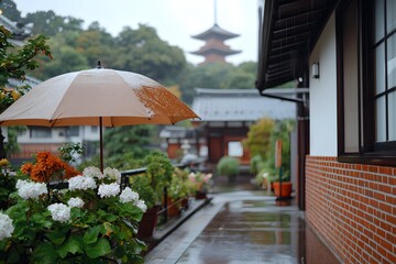 Rainy day umbrella protects flowers with temple background