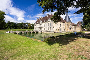 Naklejka premium Chateau de Commarin reflecting on the water in Bourgogne Franche Comte, France