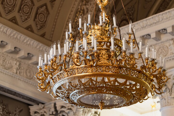 A luxurious golden chandelier adorned with intricate details