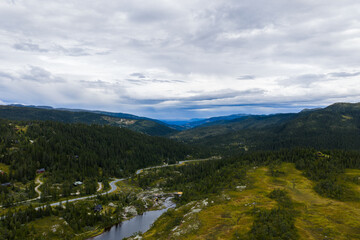 Winding road through a remote Norwegian valley landscape.