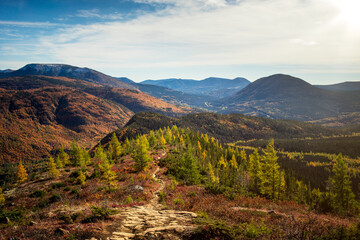 Vibrant autumn landscape showcasing mountains and valleys at sunset in a serene wilderness setting