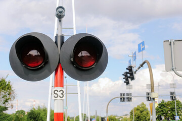 Railroad crossing traffic light. Warning signal with red lights and pole. Railway transportation system safety equipment. Closeup of train crossing light outdoors. Modern railway crossing signal.