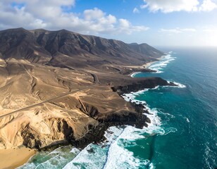 High-altitude view of a dramatic coastline with rugged mountains and a winding road