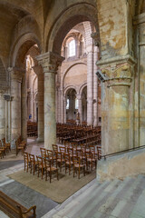 Fototapeta premium Interior of Church of Saint Hilaire le Grand showing columns, arches and chairs in Poitiers, France