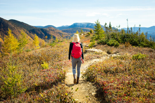 Hiking through a colorful autumn trail in the mountains on a sunny day