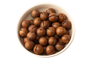 Fototapeta premium Macadamia nuts in a shell isolated on a white background.