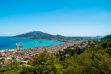 Obraz premium Panoramic view of Zakynthos Town Greece with harbor turquoise sea and green hills popular travel destination and beautiful photo spot in summer