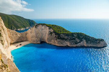 Obraz premium Panorama of Navagio Shipwreck Beach Zakynthos Greece with turquoise blue water white cliffs and sandy cove seen from above top travel destination photo spot