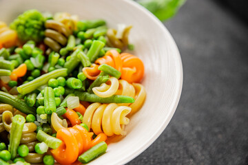 Trottole pasta vegetables green peas, green beans, kohlrabi cabbage, broccoli second course tasty snack fresh delicious gourmet food background on the table rustic food top view copy space