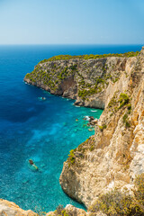 Cliffs and turquoise water of Zakynthos Greece with small boats near the shore breathtaking coastal landscape and must see travel location