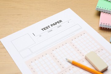 Answer sheet, eraser, pencil and notebooks on wooden table, closeup. Student passing exam