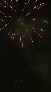 Vertical video. Fireworks on the beach to celebrate the end of the fiesta. Rare but powerful charges explode high in the sky. Mallorca Island. Spain.