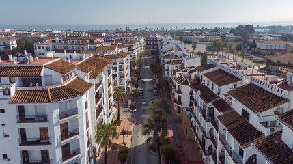 Fototapeta premium Stock aerial image of an urban city neighborhood with residential buildings, streets and rooftops, created as a resource for real estate, housing and architecture projects. Not a specific locations
