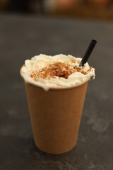 Pumpkin spice drink. Latte coffee with whipped cream in a paper cup
