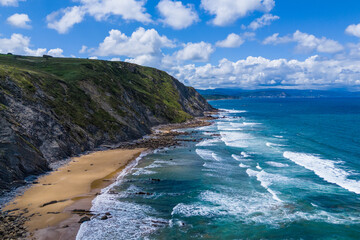 Atlantic coast and ocean. Rocks on the coastline. View from above. Blue sky with clouds. Seascape