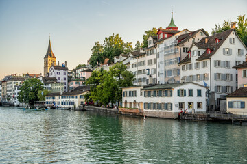 Scenic and quiet city view of Zurich and the Limmat river at sunset seen from Limmatquai in Zurich, Switzerland.