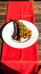 Grilled ribs on a white plate