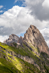 Obraz premium Dramatic mountain peak of Geisler group / Odle group in Puez-Odle nature park rising sharply against a partly cloudy sky in Val Gardena in the Italian Dolomites alps 