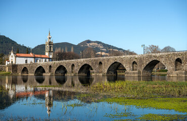 Fototapeta premium Historic Bridge and Church of Santo António da Torre Velha on a Sunny Day in Ponte de Lima, Portugal