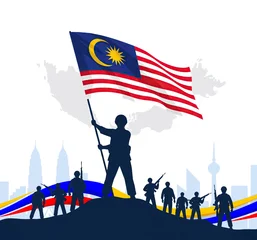 Silhouette of people raising Malaysia flag against vibrant sunset city skyline backdrop © shahrilkhmd