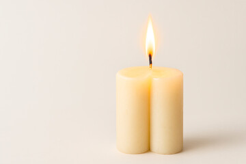 Two candles with one common flame. Space for text.