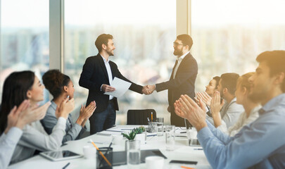Obraz premium Striking grand deal. Business people congratulating their colleagues after signing contract