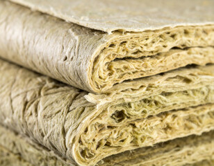Stacked Hemp Fiber Insulation Material Close-Up, Natural Building Material, Sustainable and Eco-Friendly.